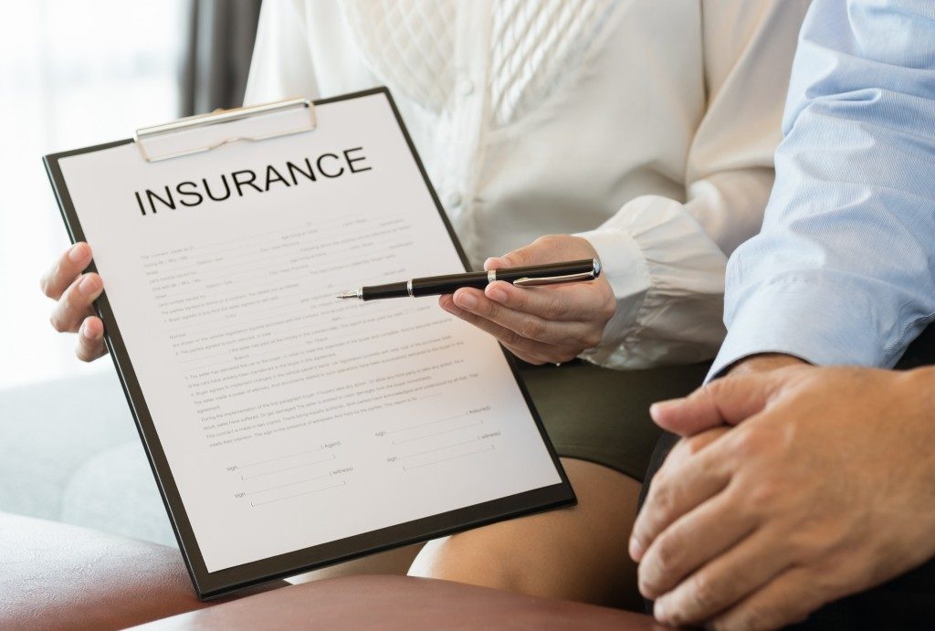 insurance agent showing a copy of policy