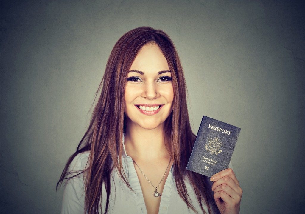 immigrant woman holding a passport