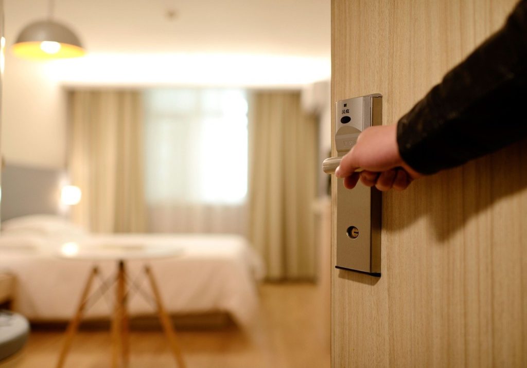 person opening a hotel room
