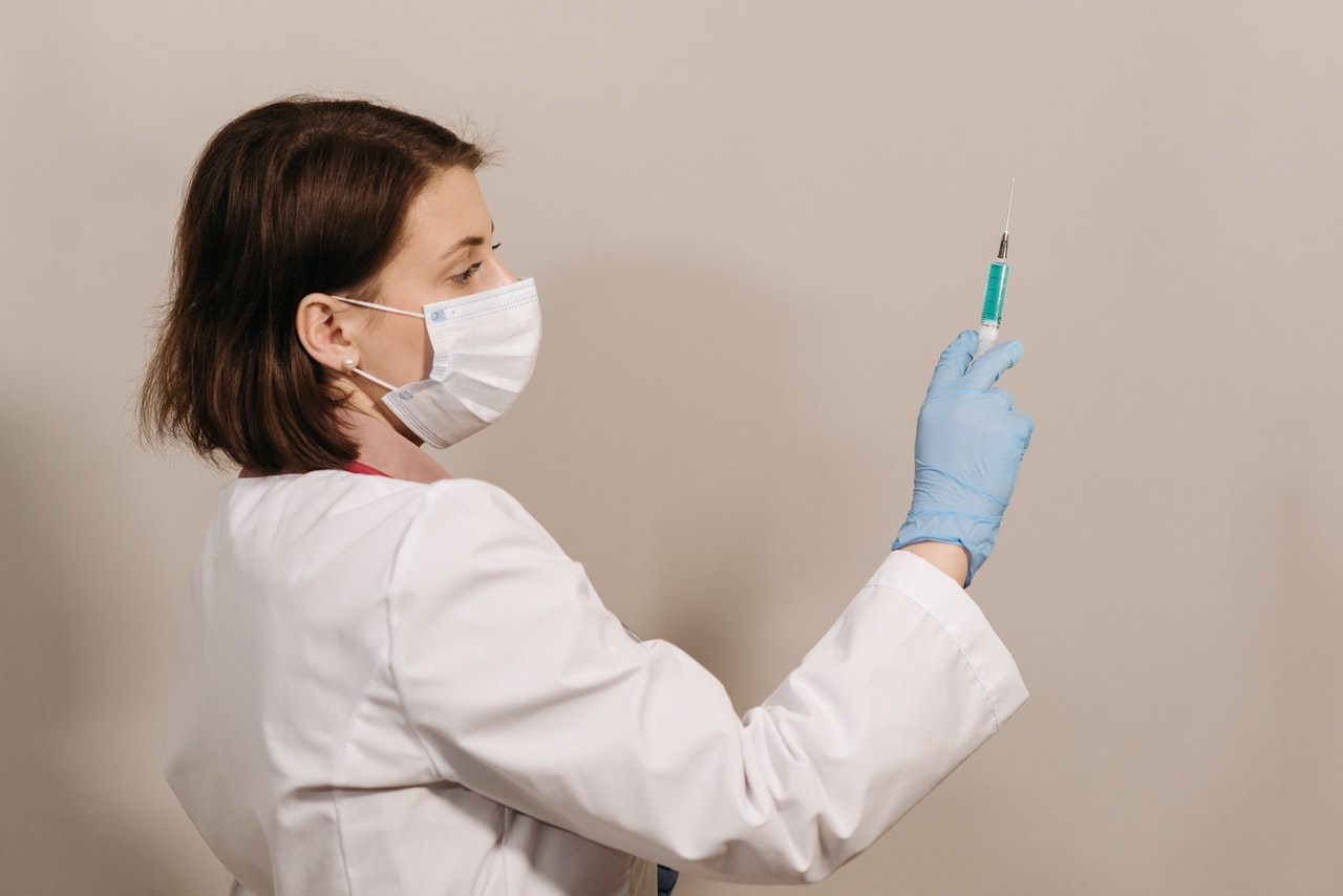 physician holding a syringe