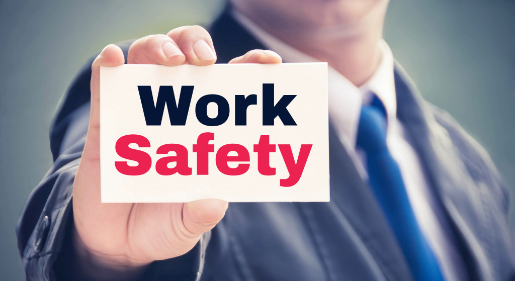 employee holding a work safety card