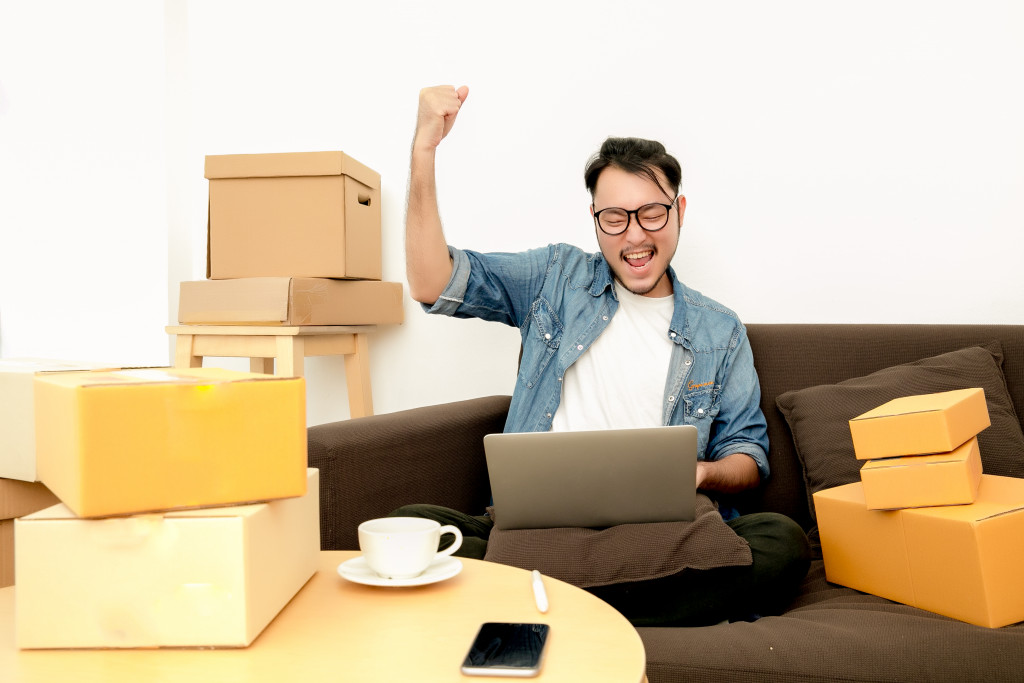 man working on the computer celebrating 