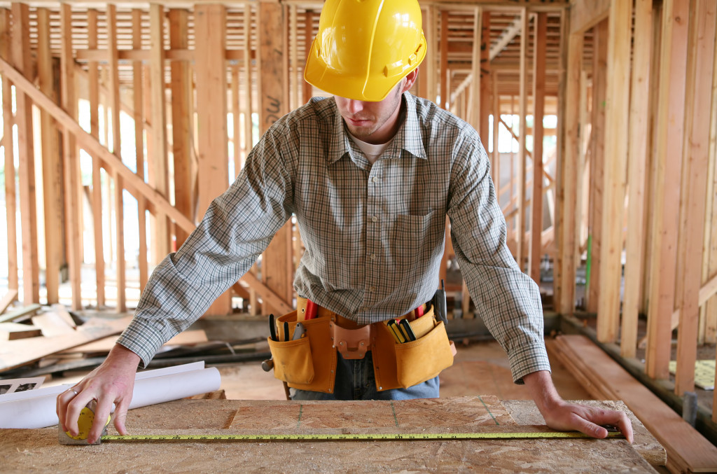 contractor measuring a panel