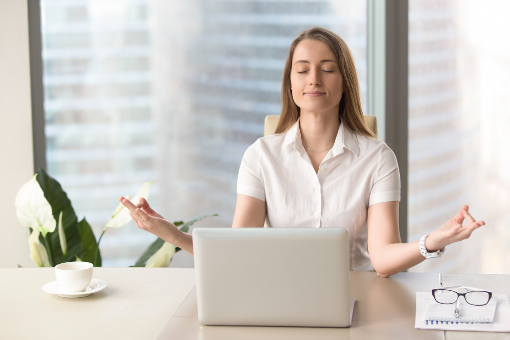 woman practicing tai chi while on work