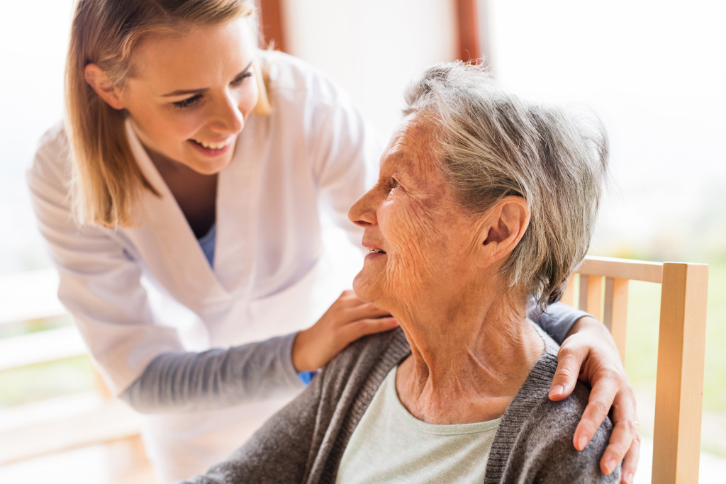 Female healthcare professional caring for an older woman