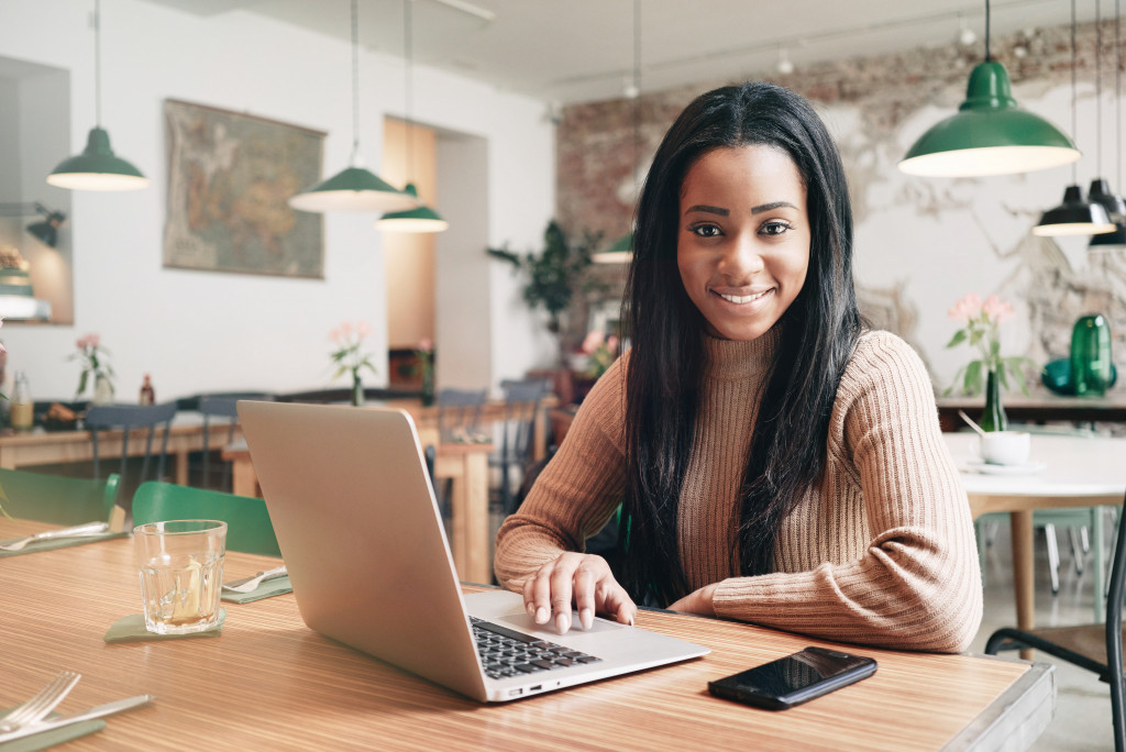 entrepreneur using her laptop inside her restaurant