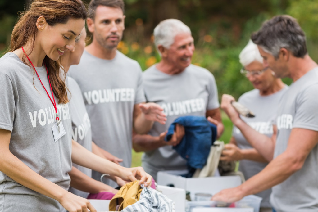 employees wearing a volunteer shirt while doing a donation