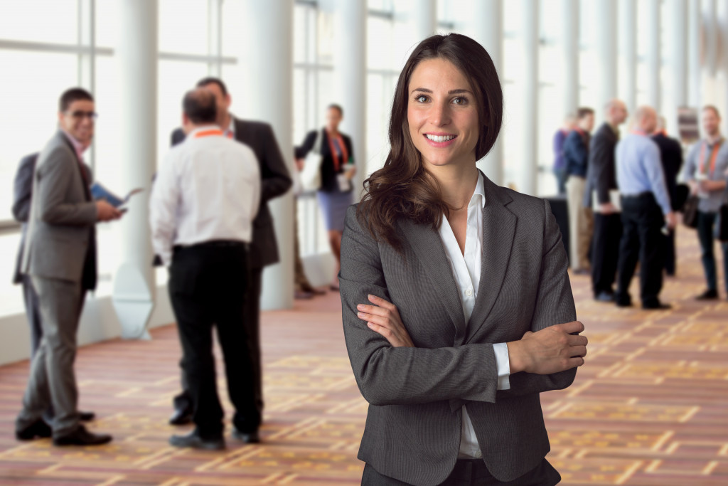 A successful woman smiles while at an industry networking event