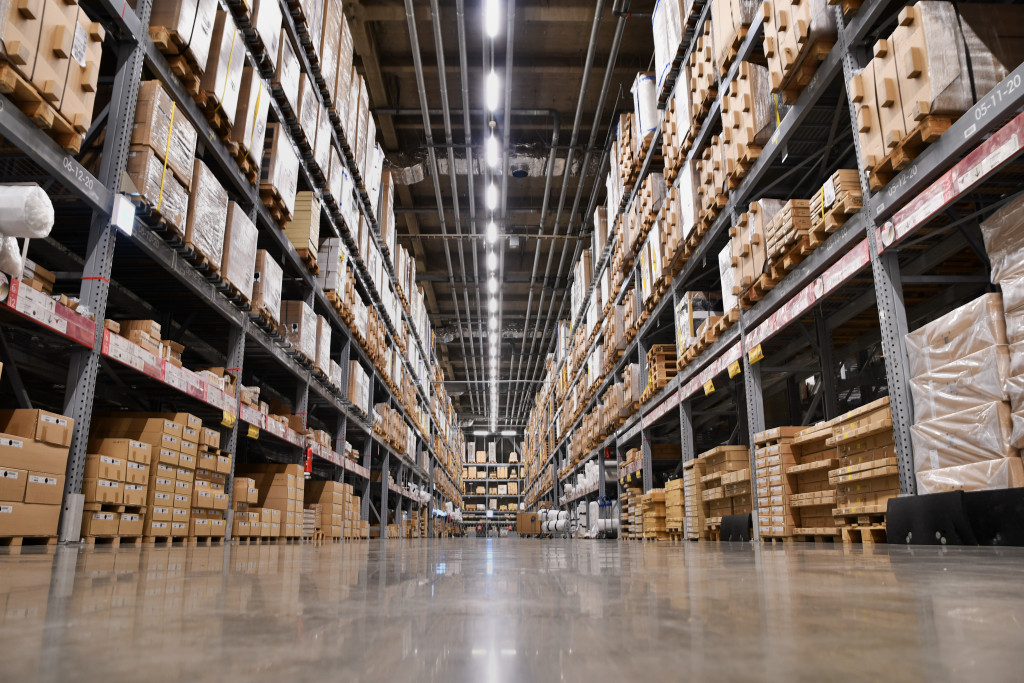 a large warehouse with various shelves full of boxes and materials