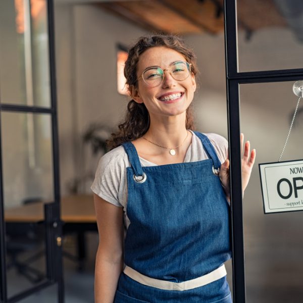 A woman at the entrance of her open business