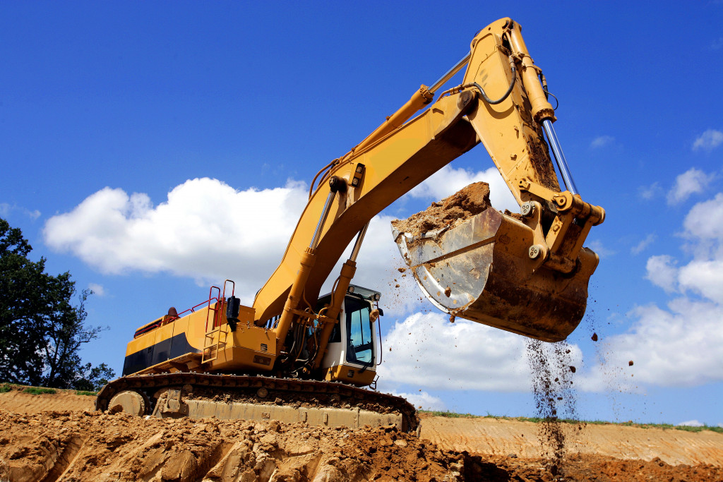 An excavator digging in a pit