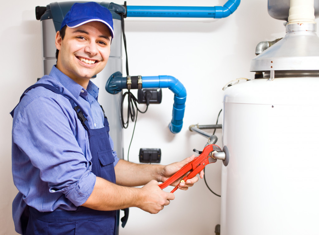 A plumber repairing a water heater