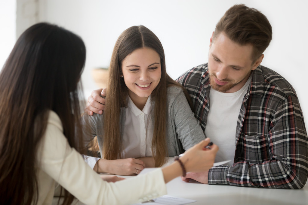 A landlord talking to potential tenants about renting