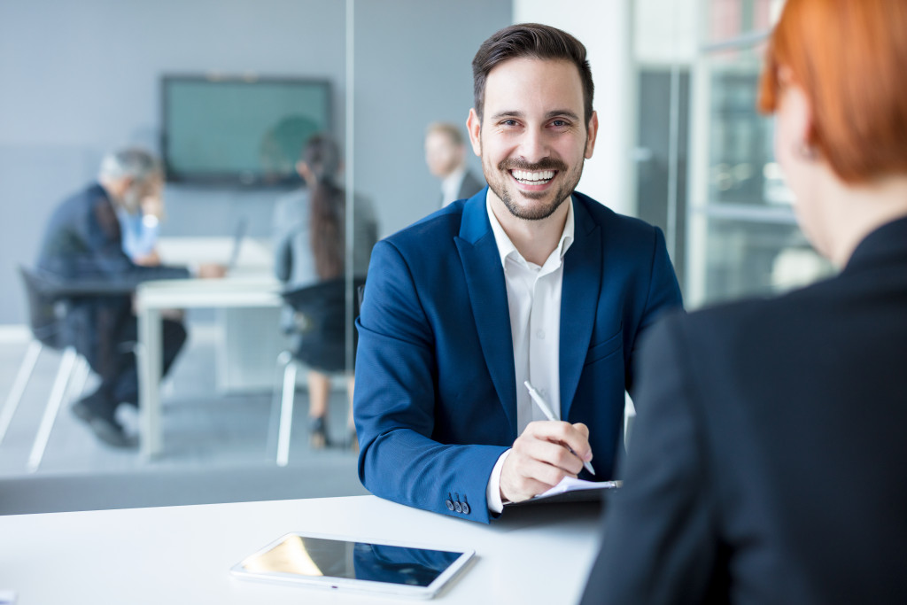 financial advisor smiling in front of his client