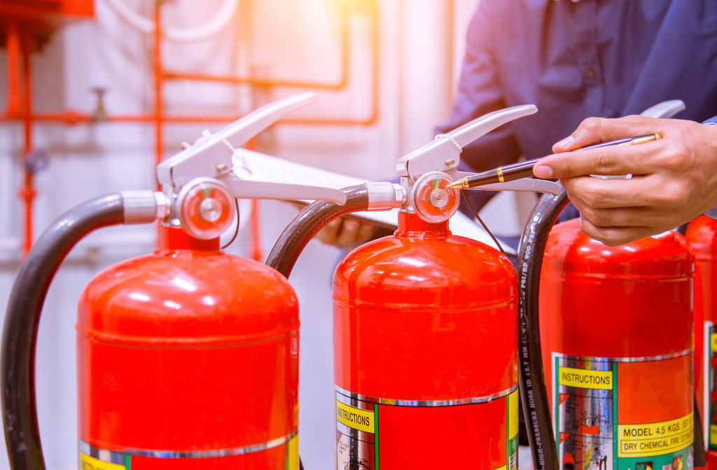 A row of fire extinguishers being inspected