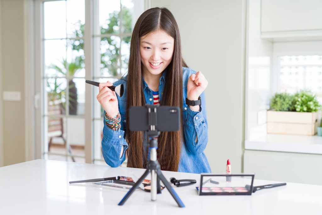 Young woman creating content using a smartphone.