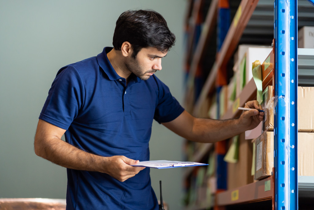 employee checking inventory in warehouse