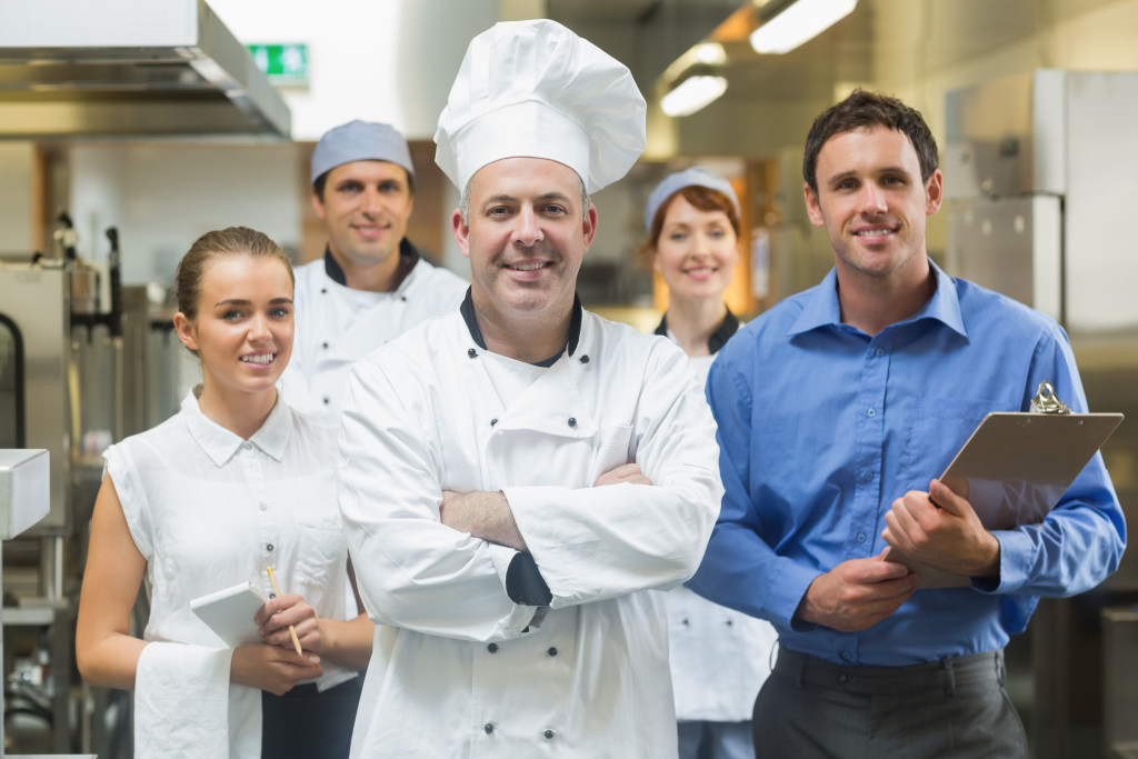 Head chef and his team posing for the camera