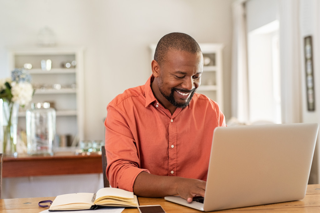 Man working from home saving money